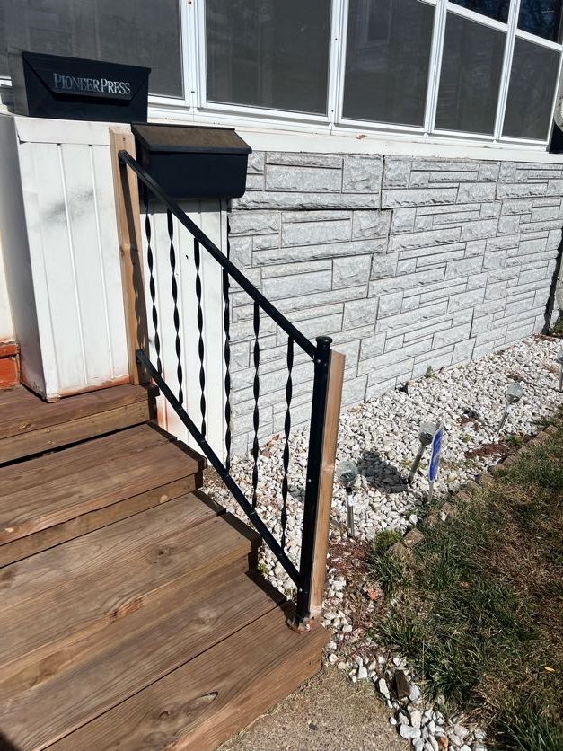 Railing along the side of front door steps